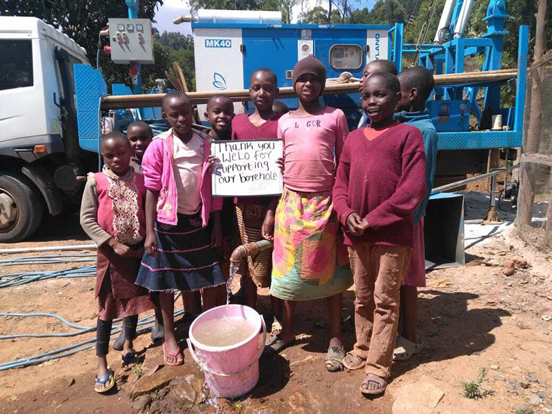 Children in Kenya in front of borehole
