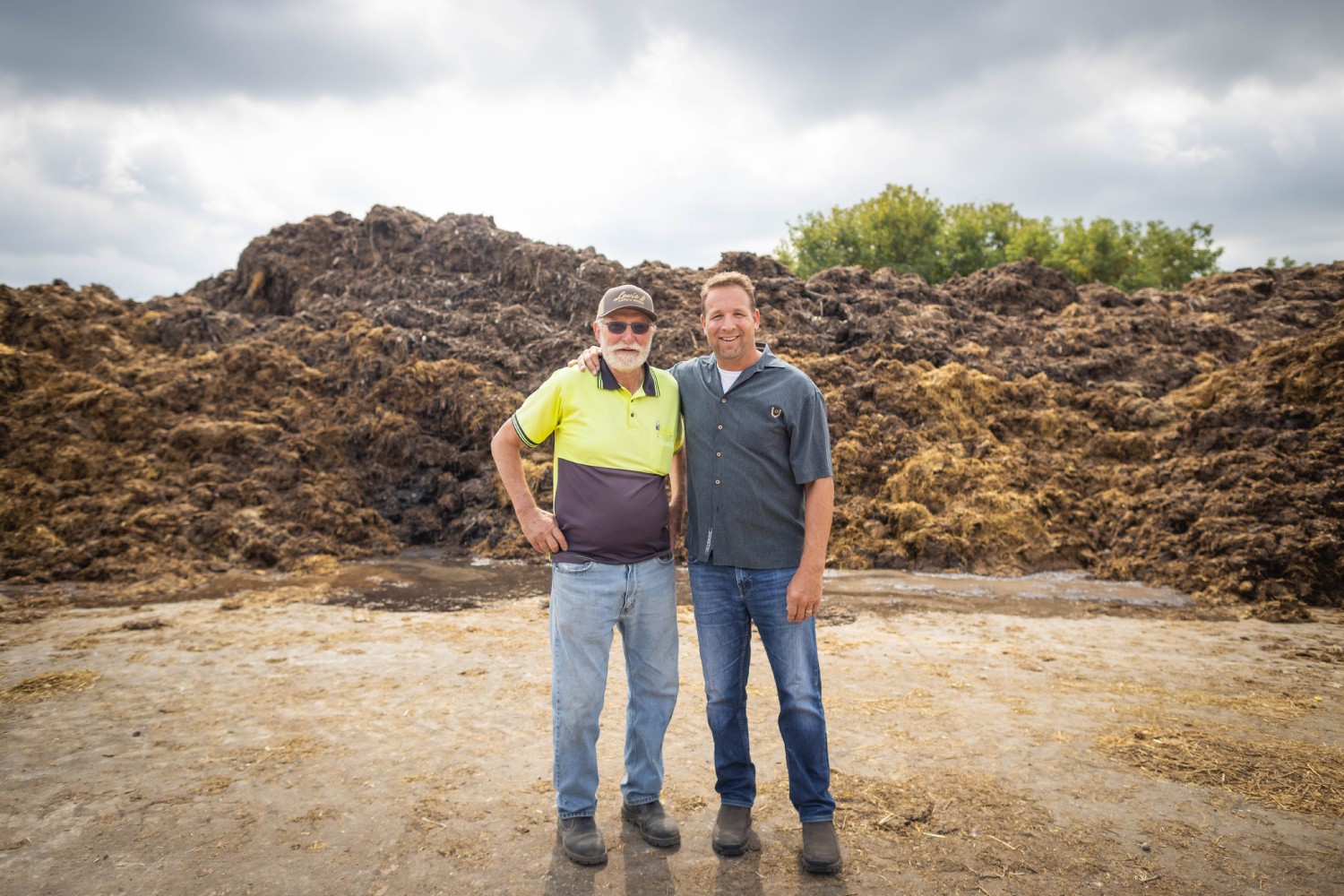 Two men standing in front of Honest Potato farm