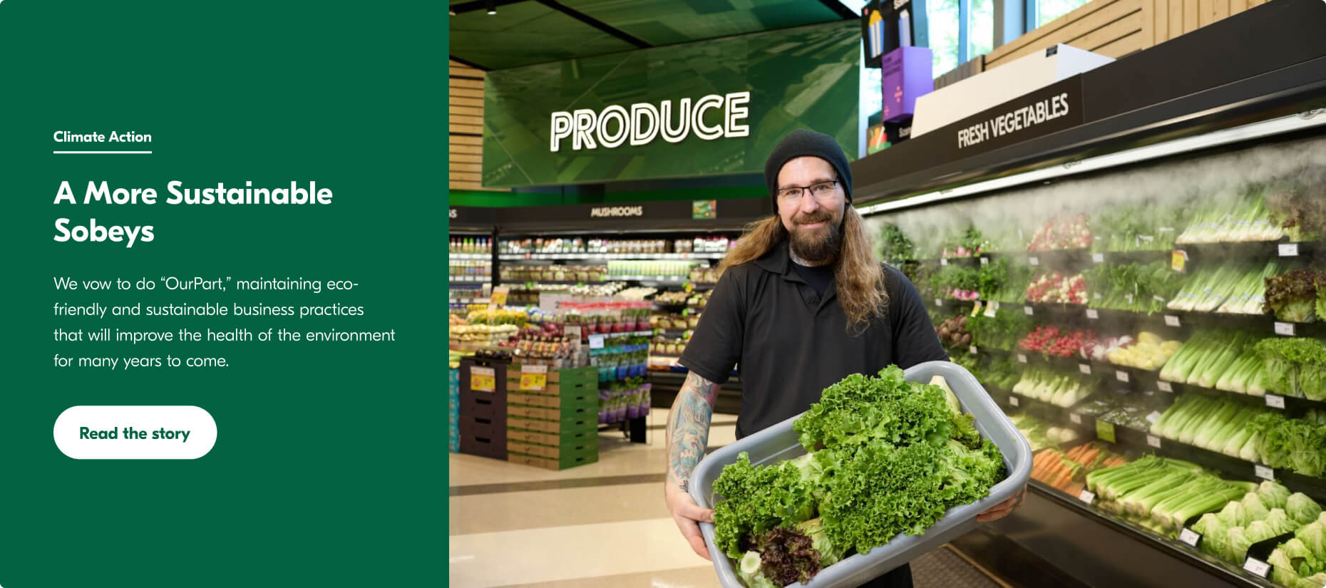 This image shows a man wearing a black cap and t-shirt. He works in a vegetable store at Sobeys and is standing with a basket full of green vegetables in front of a rack stand.